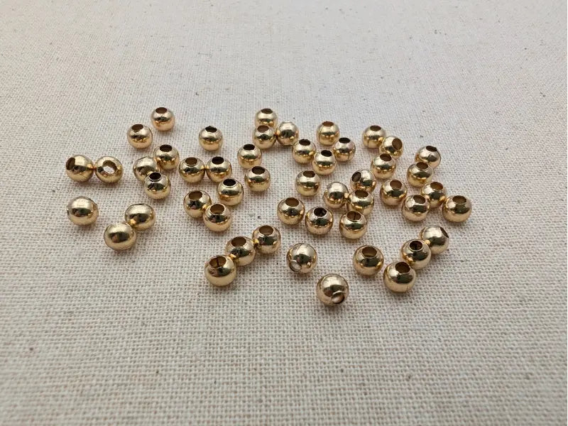 Perles intercalaires 4 mm acier inoxydable 304 plaqué or 18K – Lot de 50 ou 100 Les Précieuses Perles